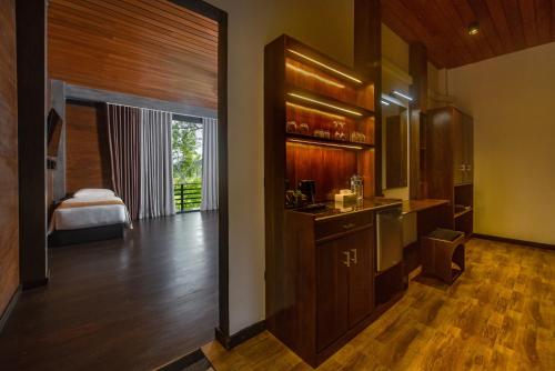 a room with a kitchen with a sink and a bedroom at Atha Resort in Sigiriya