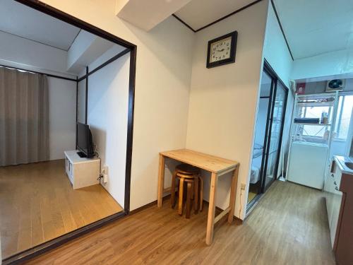 a small room with a table and a mirror at 海天ハウス花木301 in Beppu