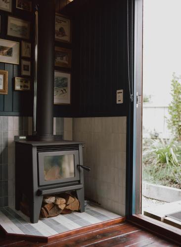 a fireplace in a living room with a stove at The Carriage - Outdoor Private Bath in Closeburn