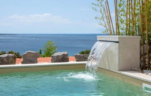 a swimming pool with a water fountain at Villa Miholascica 3 in Island Cres by Villas Guide in Cres