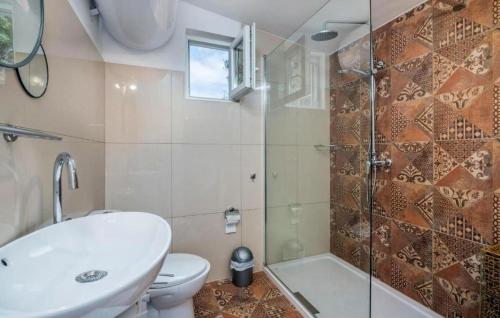 a bathroom with a toilet and a sink and a shower at Villa Miholascica 3 in Island Cres by Villas Guide in Cres