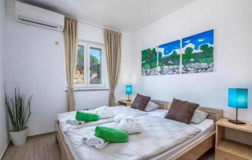 a bedroom with a bed with green pillows on it at Villa Miholascica 3 in Island Cres by Villas Guide in Cres