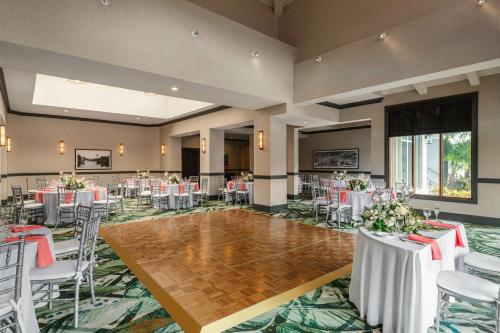 a banquet hall with white tables and chairs at Embassy Suites by Hilton Fort Lauderdale 17th Street in Fort Lauderdale