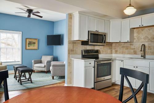 a kitchen with white cabinets and a living room at The Cadillac House Lexington, Tapestry Collection By Hilton in Lexington