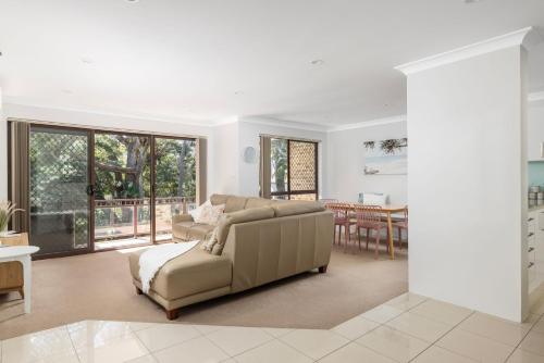 a living room with a couch and a table at 'Bay Parklands' Close to Waters Edge in Nelson Bay