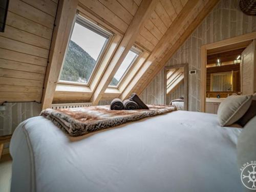 a bedroom with a large bed in a attic at CASA SOLEI en Val de Ruda in Naut Aran