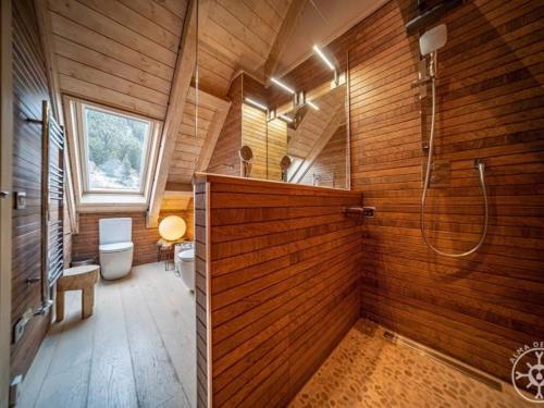 a wooden bathroom with a shower and a toilet at CASA SOLEI en Val de Ruda in Naut Aran