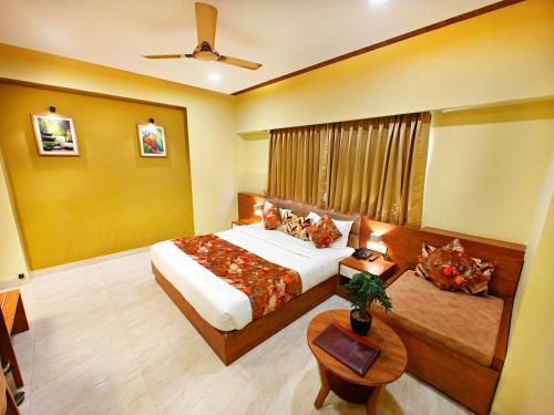 a hotel room with a bed and a table at Opulence Inn - 500 Meters From Railway Station in Udaipur