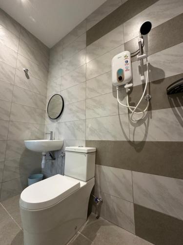 a bathroom with a toilet and a sink at De Home Kluang Homestay in Kluang