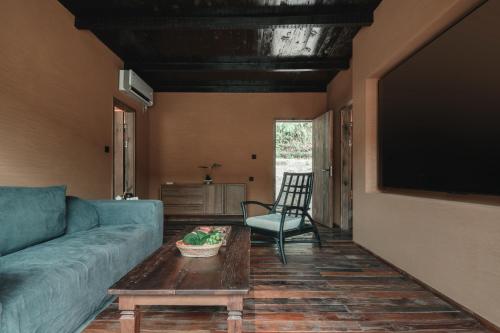 a living room with a couch and a table at YunXi ChanYi Hot Spring Hotel in Emeishan