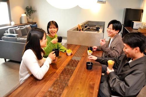 a group of people sitting around a table with drinks at Misono no Oyado - RO 美園のおやど - ろ #IO2 in Wakayama