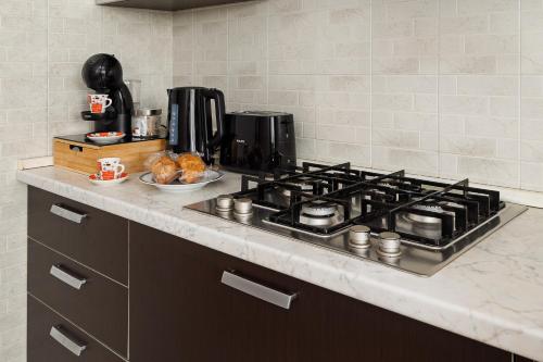 a kitchen counter with a stove top in a kitchen at NEW - Parking - 10 min from Fiera MiRHO - sleeps 4 in Baranzate