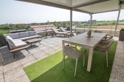 a patio with a table and chairs on a roof at Apartmaji Aida in Moravske Toplice