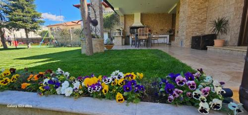 a flower bed of colorful flowers in a yard at Garden's House Pozar in Aridaia in Aridaia
