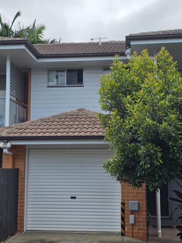 a garage door in front of a house at Kallangur 3 Bedroom Townhouse in Kallangur