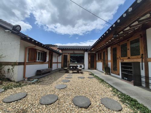 a courtyard of a house with rocks on the ground at Jeonju Tosarang Guesthouse in Jeonju