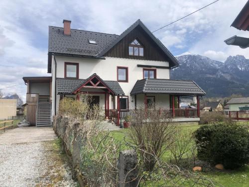 a white house with a black roof at Ferienwohnung am Sonnenweg in Admont