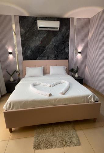 a bed with a heart made out of towels at Natalie water park chalet in Al Kafrayn