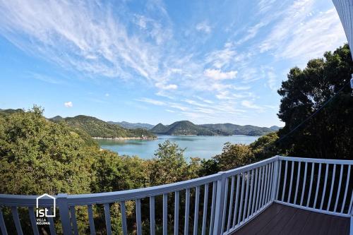 a view of a lake from a house balcony at IST Villa 04 Perfect Retreat with Ocean Views in Bizen