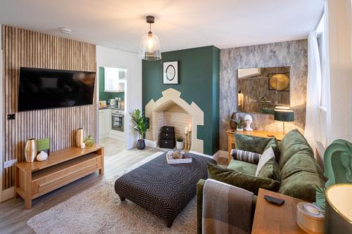 a living room with a couch and a fireplace at Character, Comfort and Convenience, No 5 Rosedene Mews in Marske-by-the-Sea