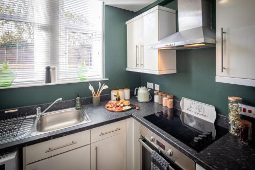 a kitchen with a sink and a counter top at Character, Comfort and Convenience, No 5 Rosedene Mews in Marske-by-the-Sea