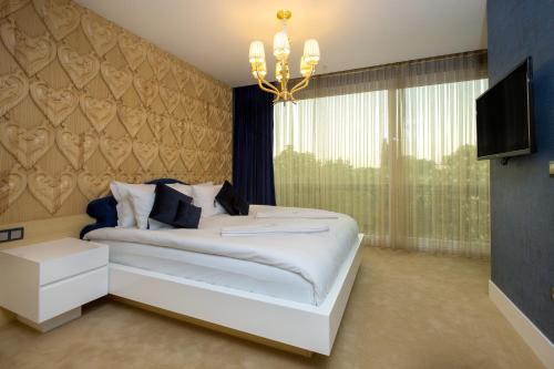 a bedroom with a white bed and a window at Golden Pars Hotel in Bursa