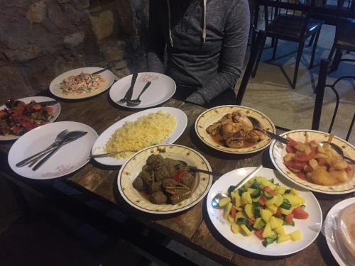 a wooden table with plates of food on it at Wadi Dana Lodge - نزل وادي ضانا in Dana