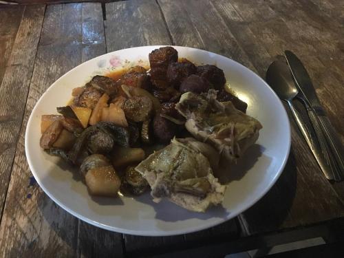 a plate of food with potatoes and mushrooms on a table at Wadi Dana Lodge - نزل وادي ضانا in Dana