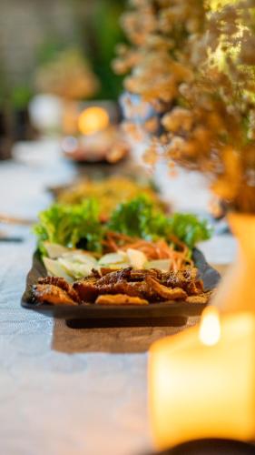 a table with plates of food on a table at House of Pi Pleiku in Pleiku