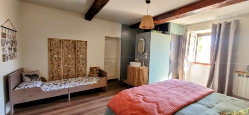 a bedroom with two beds and a mirror at La Colline Gersoise-Piscine-Sauna in La Sauvetat