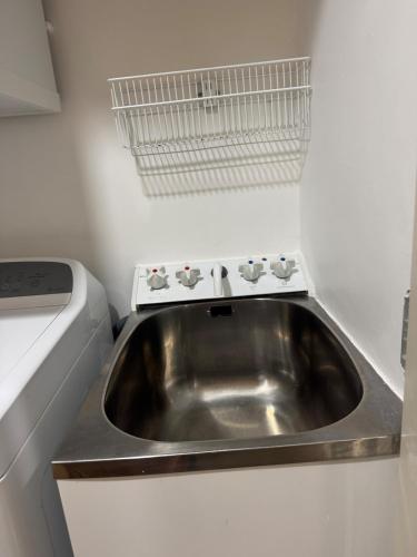 a stainless steel sink in a small kitchen at Penthouse Delight 3 bd 2 bth free carpark, pool & tennis court in Auckland