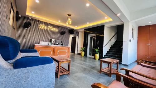 a lobby with blue chairs and a table and stairs at The Plaza - 100 feet Road, Near Indira Gandhi Statue, Pondicherry - JR Groups in Puducherry