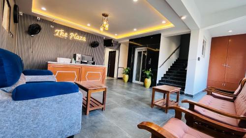 a living room with a couch and chairs and stairs at The Plaza - 100 feet Road, Near Indira Gandhi Statue, Pondicherry - JR Groups in Puducherry
