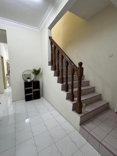 a hallway with a staircase in a house at Teratai Bunda Homestay Tambun in Tambun