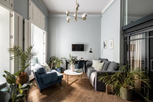 a living room with a couch and chairs and a table at Moja Apartments Krakow Old Town in Krakow