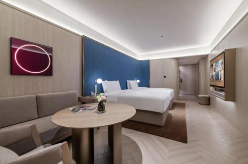 a hotel room with a bed and a couch at Crystal Orange Hotel Shanghai Chongming Nanmen in Shanghai