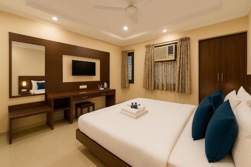 a bedroom with a bed and a desk and a mirror at Travelling Troopers Homestay in Varanasi