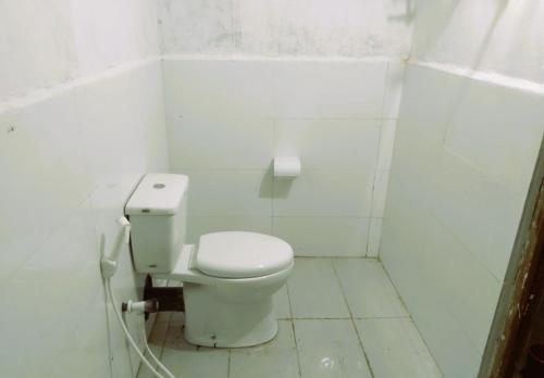 a bathroom with a toilet in a white room at Delft Cultural Home Stay in Delft East