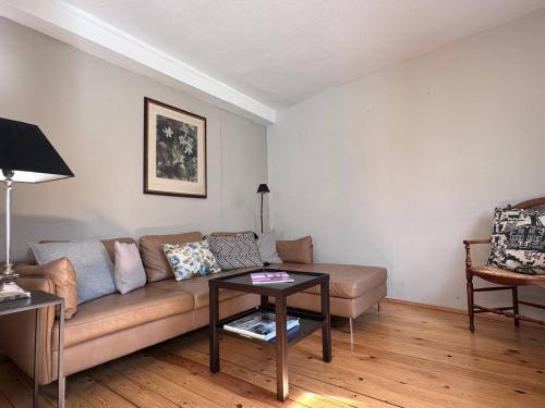 a living room with a couch and a table at seeglueck HÄUSLE - Charmantes Ferienhaus mit Innenhof in zentraler Altstadtlage von Konstanz in Konstanz