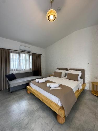 a large bedroom with a large bed and a couch at Luvenza Hotel Alaçatı in Çeşme