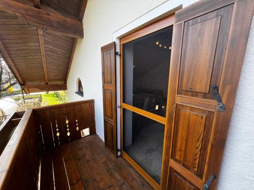 an open door to a balcony with a wooden door at Biohof Liebhart in Obing