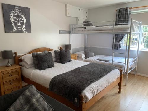 a bedroom with two bunk beds and a couch at Meerkat Manor in Coddington
