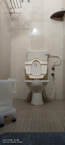 a bathroom with a white toilet in a room at The Ashish Luxury Stay in Chittaurgarh