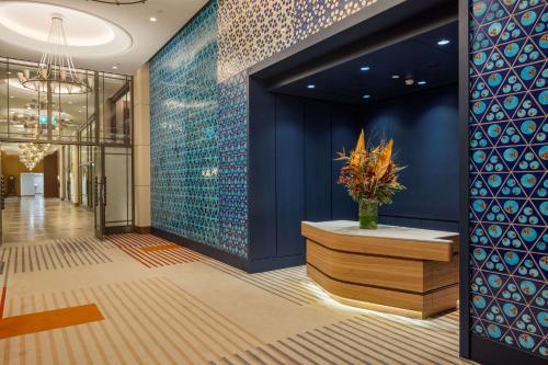 a lobby with blue walls and a vase of flowers at Hilton Istanbul Bosphorus in Istanbul