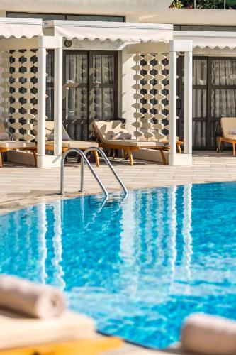 a swimming pool at a hotel with blue water at Hilton Istanbul Bosphorus in Istanbul