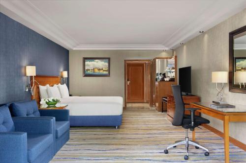 a hotel room with a bed and a desk at Hilton Istanbul Bosphorus in Istanbul