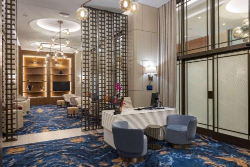 a lobby with a waiting area with chairs and a desk at Hilton Istanbul Bosphorus in Istanbul