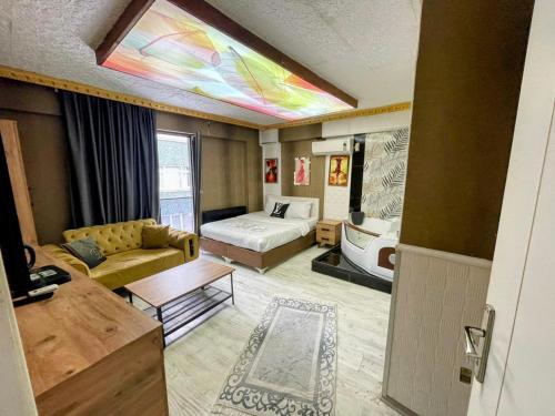 a living room with a couch and a bed in a room at Royal Suite Hotel in Istanbul
