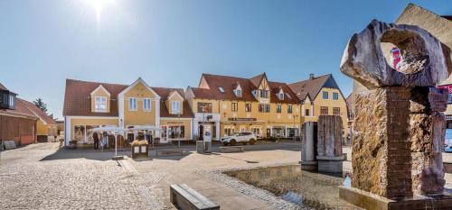 a town with a statue in the middle of a street at Nærvær i Skagen in Skagen