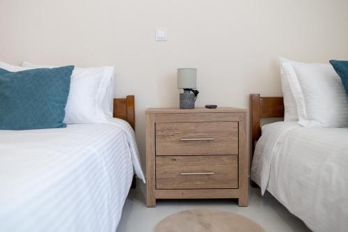 a bedroom with two twin beds and a nightstand at Natalia's Nest in Ampavris